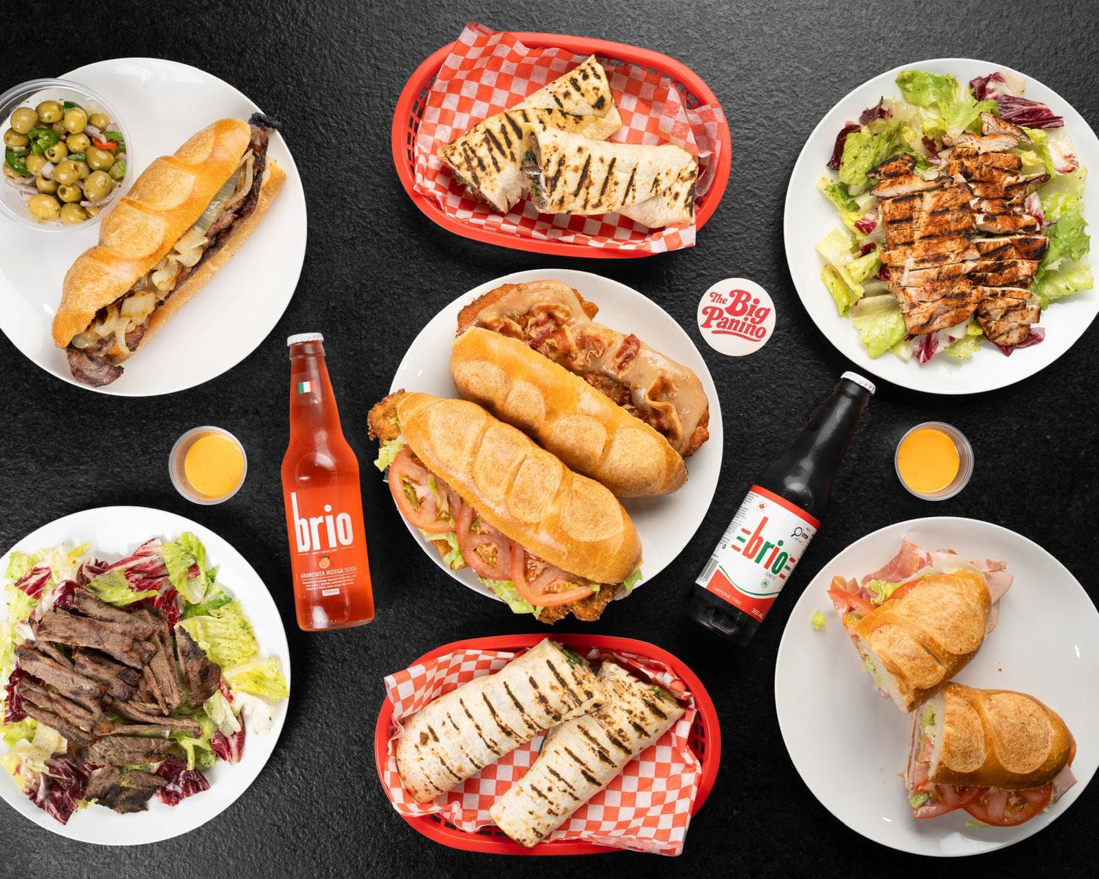A catering spread of Big Panino hoagies, paninos, wraps and salads